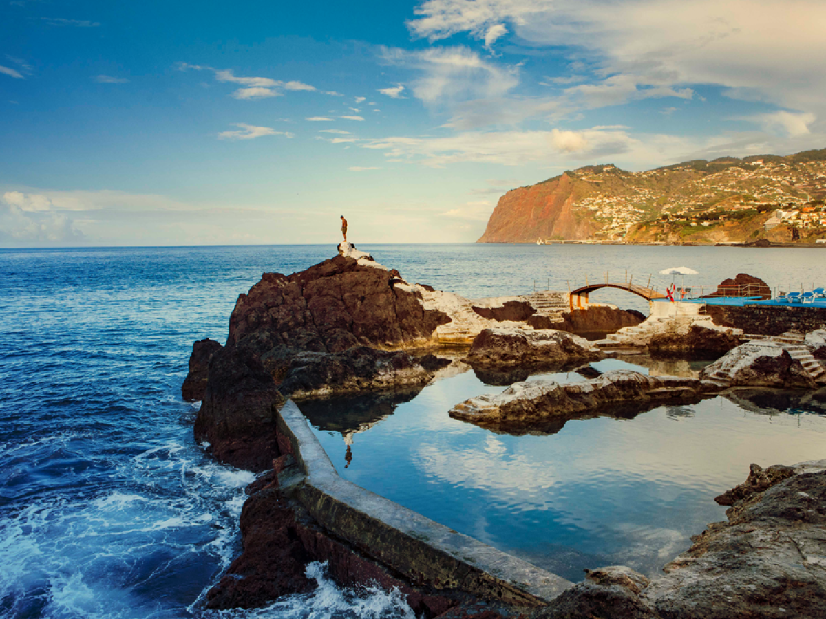 a rocky beach next to a body of water